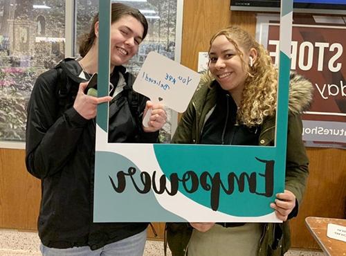 Students holding Empower sign